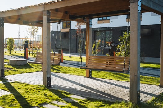 A vibrant and lively outdoor playground featuring beautiful wooden swings set in a contemporary park environment, perfect for enjoyment and adventure photo