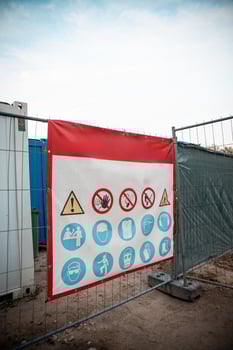 Construction Site Entrance with Safety Sign and Metal Fence photo
