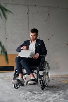 A director in a suit sitting in a wheelchair, using a ball in a modern office, embodying adaptability, focus, and leadership while navigating challenges in the workplace photo