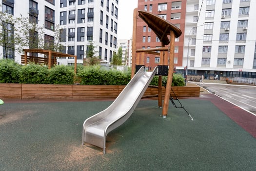 A contemporary playground slide designed for urban environments, featuring safety enhancements for children photo