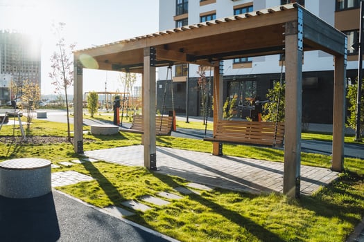 In the center of the park, there exists a beautifully constructed wooden pergola that enhances the outdoor space, providing a charming area for relaxation and leisure activities photo