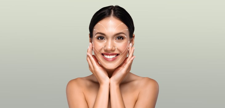 A woman engages in her skin care routine, gently touching her face with a joyful expression. The calm atmosphere highlights her commitment to beauty and self-care. photo