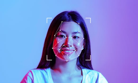 A woman smiles as facial recognition technology maps her features against a vibrant background. The process highlights the intersection of technology and human expression in modern identification. photo