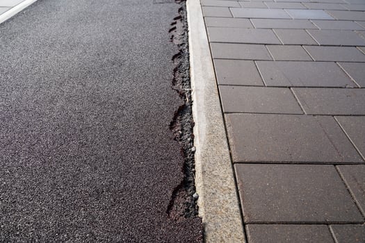 The damaged sidewalk resulting from significant ground movement has a notable impact on urban infrastructure photo