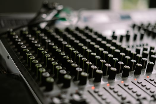 Close-up view of a sound mixer with numerous knobs and faders, ideal for music production so nice photo
