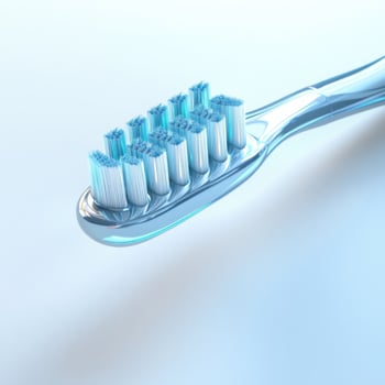 Close-up view of a modern toothbrush with blue bristles on a soft background photo