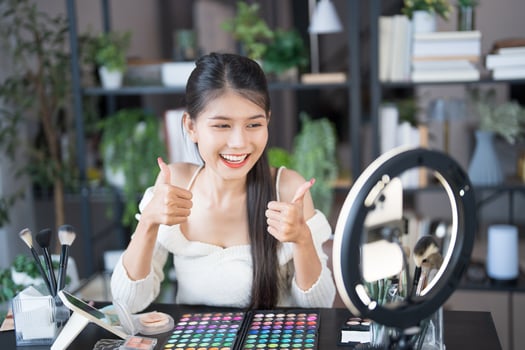 Beauty influencer Asian girl Using Social Media for live streaming on Smartphone online audience like and subscribe to her channel photo