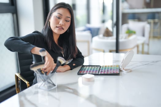 Asian girl makeup artist Professional Woman blogger vlogger is showing cosmetics products with recording Beauty influencer asian girl online marketing. photo