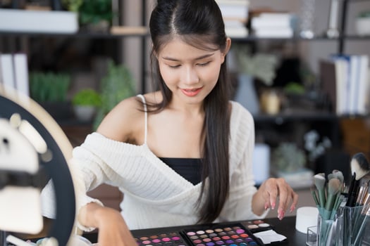 a beauty blogger woman is working on her makeup in a makeup room photo