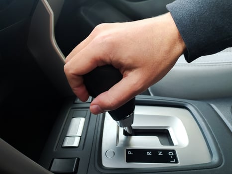 Closeup of a hand shifting an automatic car gear. Clean, modern interior. Perfect for automotive, transportation, or drivingrelated content. Ideal for blogs, websites, and marketing materials. photo