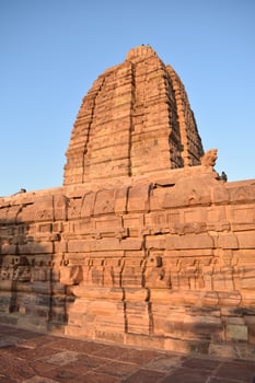 The sun is shining on a large stone structure photo