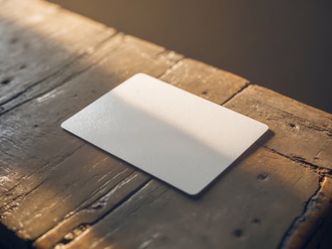 Blank card on wooden table with soft shadows photo