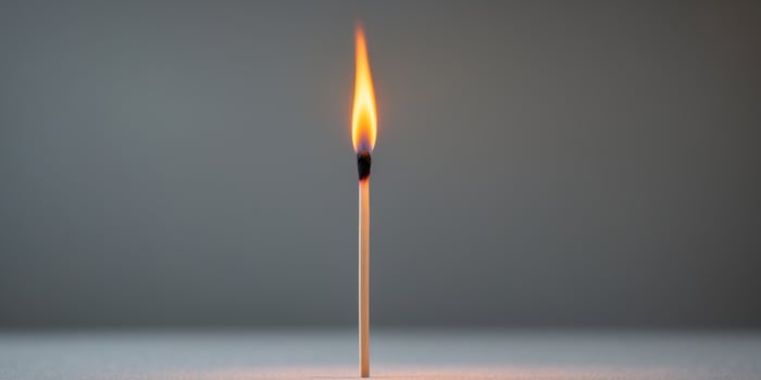 Matchstick is lit and the flame is yellowMatchstick is lit and the flame is yellow. photo
