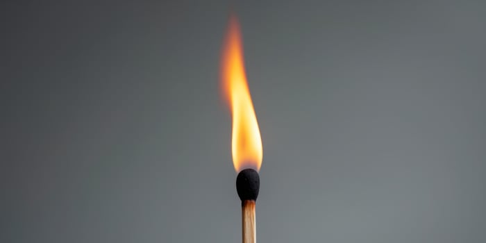 Matchstick is lit and the flame is yellow photo