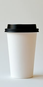 Simple white disposable cup ready for coffee or tea service in modern cafes photo