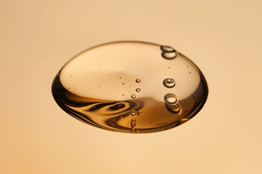 Tasty texture of cosmetic gel on a golden background. photo