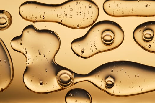 The beautiful texture of the cosmetic serum on a gold background that takes up most of the photo. photo