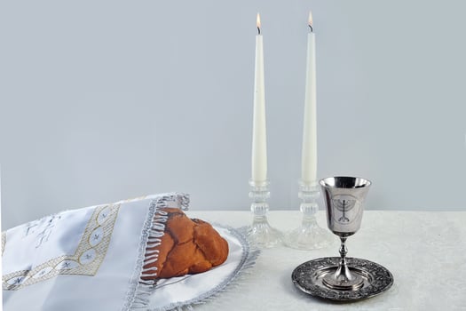 Sabbath Table Setting. Challah bread, candles, and a kiddush cup photo