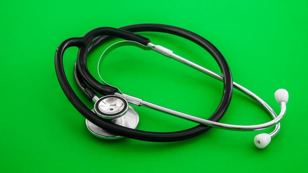 Professional stethoscope on a green background signifying medical examination and healthcare photo