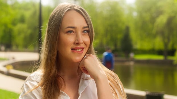 European woman female biting lip flirting smiling desire facial expression glamour beauty sensuality pointing finger fashion communicate emotional park city lady positive confused anticipation girl photo