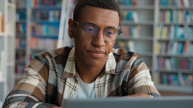 Bored African American man male guy tired fatigue overworked library high school university diploma challenge task homework student laptop e-learning desktop computer working deadline cyberspace web photo