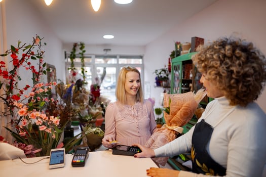 Joyful interaction between florists in a vibrant flower shop during the day photo