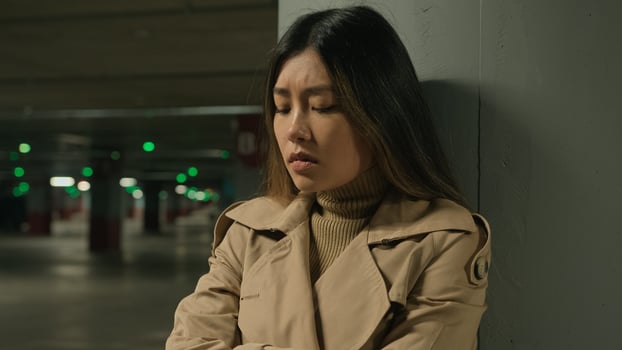 Upset anxious stressful Asian chinese woman female girl alone in car parking underground think difficult thoughts worried bad memories quarrel problem trouble suffer depression fatigue stress sorrow photo