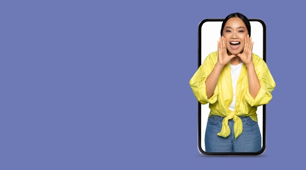 A person enthusiastically interacts with friends via a large smartphone screen, showcasing the importance of social media in modern communication. The individual appears joyful and connected. photo