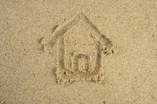 House drawn on beach sand photo