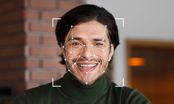 A man smiles as facial recognition technology scans his features. The background is softly blurred, emphasizing the subject's joyful expression and the innovative tech overlay. photo