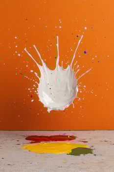 Abstract paint splash background Colorful paint splatters on orange background photo