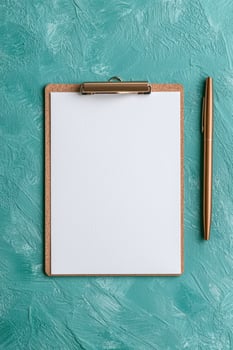 Blank clipboard mockup with gold pen on teal background photo