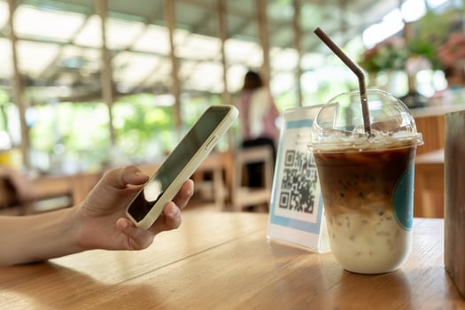 Woman use smartphone to scan QR code to pay in cafe restaurant with a digital payment without cash. Choose menu and order accumulate discount. E wallet, technology, pay online photo