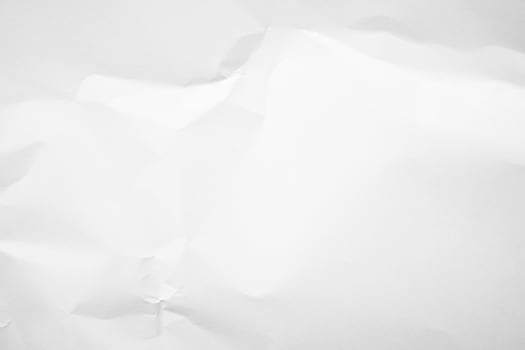 white paper crumpled up on a white surface photo