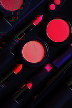 A close up of makeup products, including lipstick, eyeshadow, and blush photo