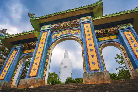 Beautiful Gate of Linh ung Pagoda and White Lady Buddha with blue sky at Chua Linh Ung Bai But Temple, Da Nang, Vietnam. photo