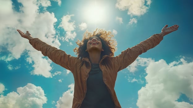 A woman with her arms outstretched in the air photo
