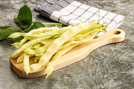 A wooden cutting board with beans on it photo