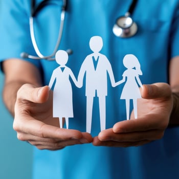 Healthcare professional demonstrating family care with paper cutouts in hands in a medical setting photo