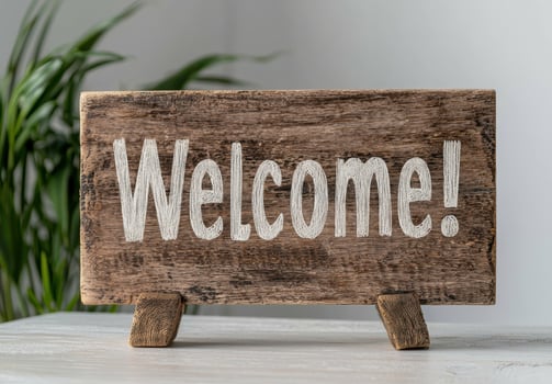 Rustic wooden welcome sign on a white table photo