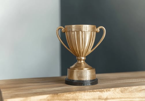 Gold trophy on wooden table photo