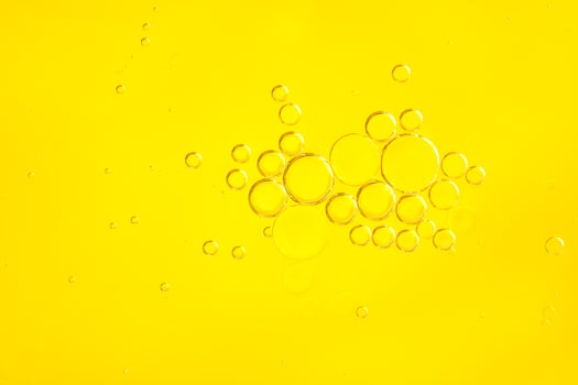 Beautiful cosmetic background. Golden orange yellow abstract oil bubbles or face serum background. photo