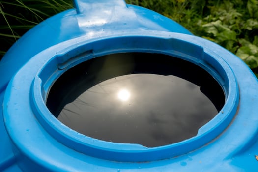 water collection tank under a roof with a drain, rain water harvesting architecture photo