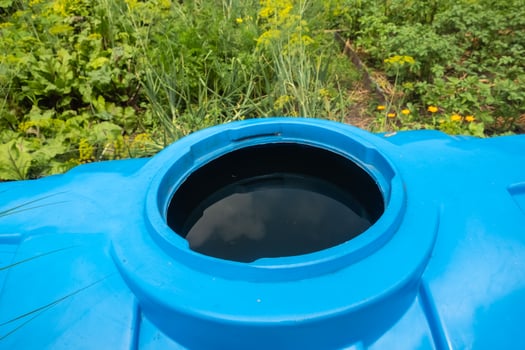 water collection tank under a roof with a drain photo