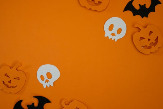 Pumpkin and skull paper cut out for copy space background photo