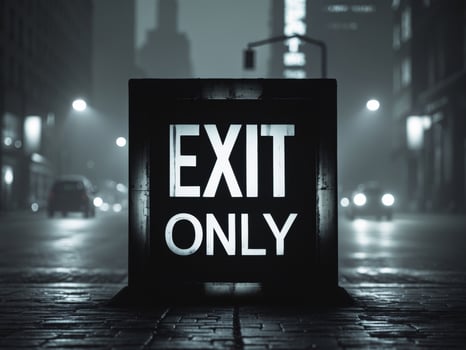 Silhouette of Exit Only Sign on City Street at Night. photo