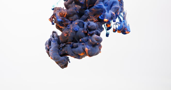 A blue and orange liquid is floating in the air photo