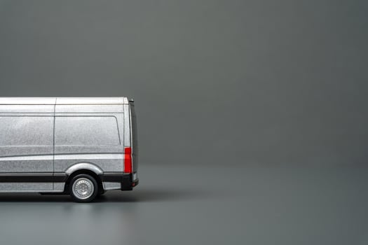 Gray van for delivery of goods and logistics and gray background, space for text. Delivery of products to stores. Services. Capacious transport for transportation. photo