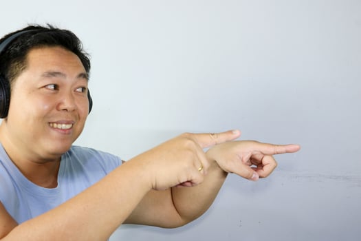 Happy Man Pointing finger with wearing Headphones photo