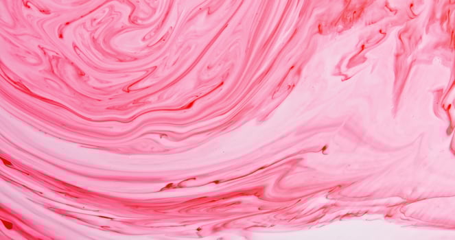 A close up of a pink liquid with swirls photo